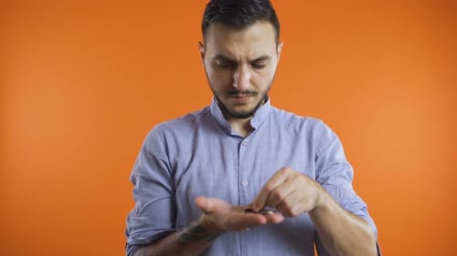 Young Man Counting Coins on His Hand