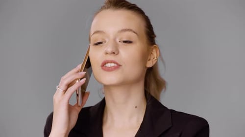 Female Entrepreneur Talking on Smartphone in Studio