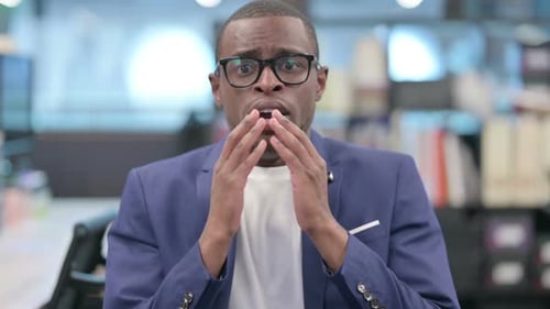 Man Reacts with Shock and Disbelief in Office