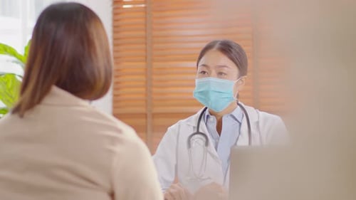 Doctor Consults with Patient in Sunny Office