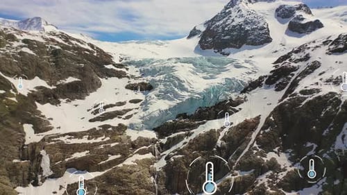 Aerial drone shot between snowy glacial mountains melting during global warming on earth - Climate a