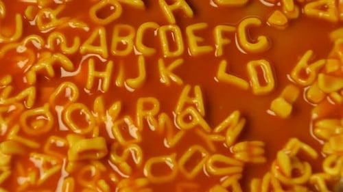Alphabet Pasta Spelling in Tomato Sauce Close Up
