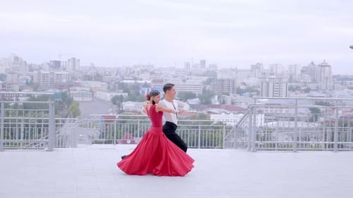 Beautiful Couple Dancing Against the Backdrop of the City.