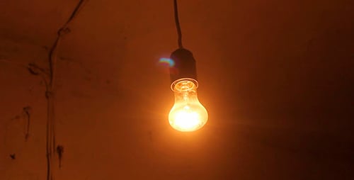 Single Light Bulb Illuminates in a Dark Room