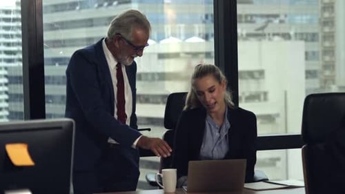 Business Discussion Between Man and Woman in Office
