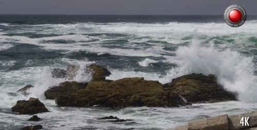 Crashing Waves on Rocky Coastline under Overcast Sky