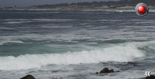 Waves Crashing on Rocky Shoreline during the Day