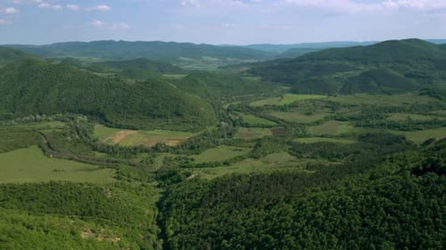 Picturesque spring valley between green hills