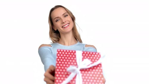 Woman Offers Festive Gift Box with a Smile
