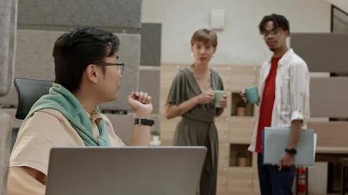 Male Asian Office Worker Asking Colleagues for Help