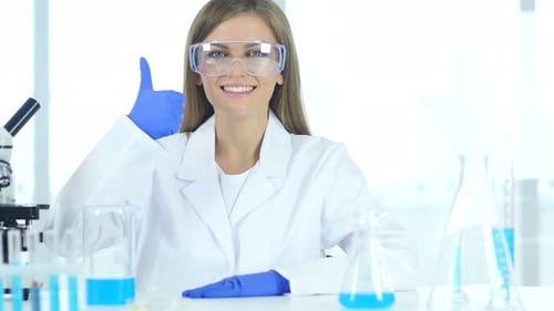 Female Scientist Gives Thumbs Up in Lab