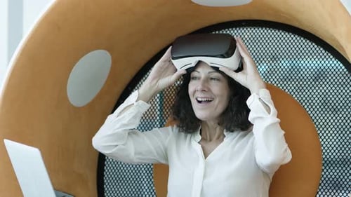 Woman Using VR Headset in Modern Workplace