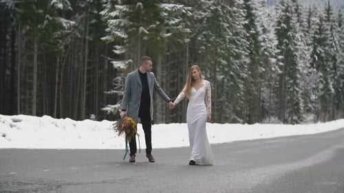 Young Couple Riding on the Road in the Forest