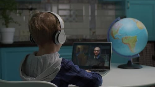 Child Engages in Online Learning with Laptop