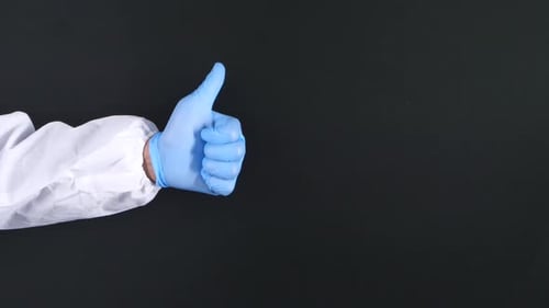 Close-up of a Tow People Hand in Medical Gloves Showing a Thumb-up.