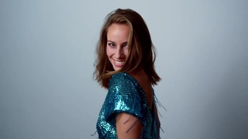 Attractive Woman in Sequined Top Dancing and Smiling