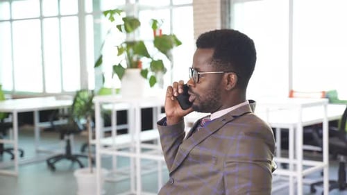 Young Adult Male on Mobile Phone in Office