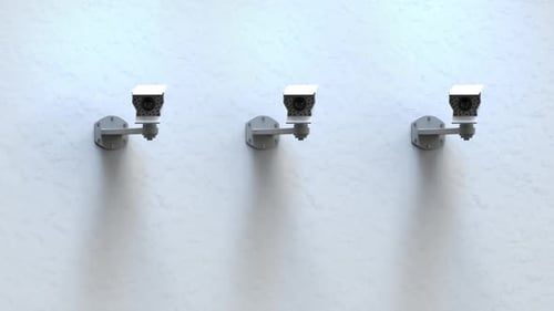 Three Modern Security Cameras Monitoring a Wall