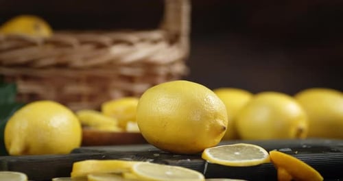Bright Lemons Scattered on a Dark Wooden Cutting Board