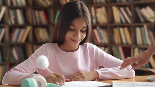 Happy Indian Latin Kid School Girl Pupil Studying at Home with Mom or Tutor