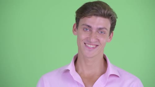 Smiling Young Adult Man Portrait on Green Background