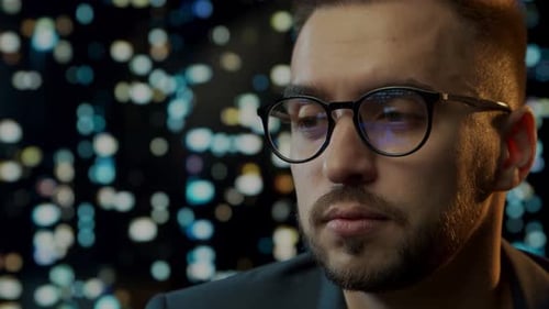 Close-up portrait of a young man working at the computer.