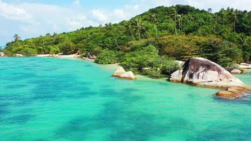 Paradise exotic beach with calm clear turquoise lagoon washing beautiful cliffs and white sand on tr