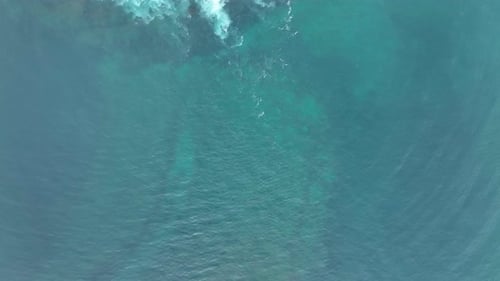 Waves Crash Against Rocks in the Ocean