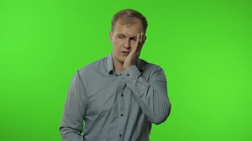 Sleepy Bored Guy Looking at Camera Not Interested in Communication. Man on Chroma Key Background