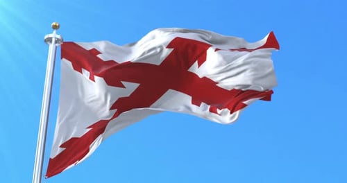 Cross of Burgundy Flag Waving Against Blue Sky