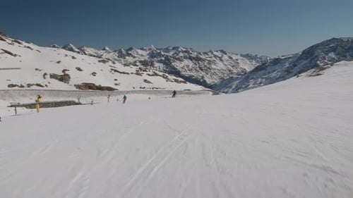 Ski Slope With Other Skiers In View And Mountains Beyond