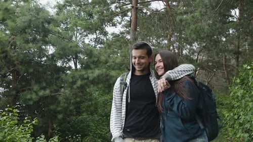 Lovely Couple in Forest, Talking, Smiling and Looking Into the Distance