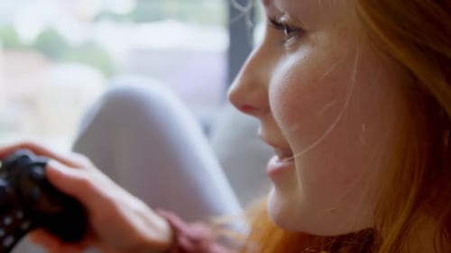 Young Adult Playing Video Game at Home
