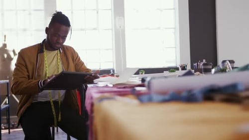 Mixed race man working in fashion office