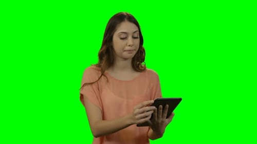 Young Woman Using Tablet on Green Screen