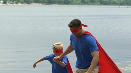 Father and Son Superhero Duo Posing by Lake