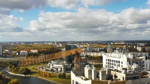 Close-up Aerial Panorama of Yellow Construction Crane During Development Process of High Rise Tower