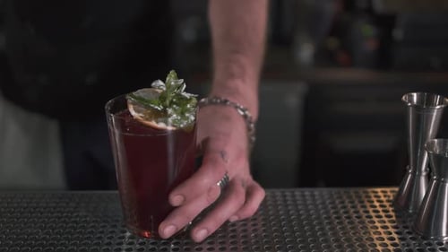 Fresh Cocktail Decorated with Mint and Orange Standing on Bar Counter
