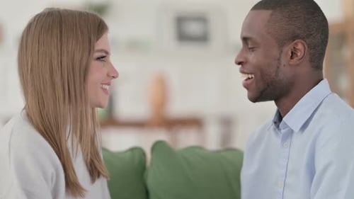 Smiling Woman and Man in Conversation Indoors