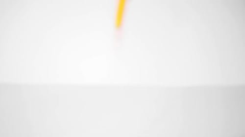 Colorful Pencils Falling onto White Background