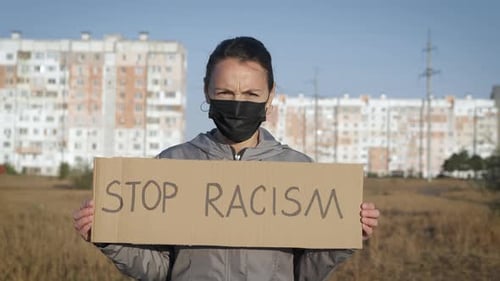 Young Adult Protests Racism in Field