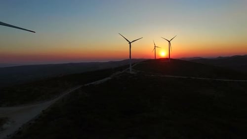 Aerial view of windmills at beautiful colorful sunset