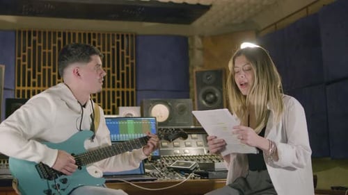 Two Musicians Working in Music Studio While Recording New Song