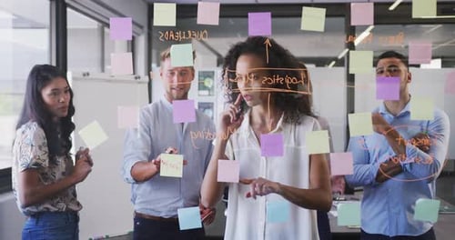 Professional businesswoman writing on glassboard in modern office in slow motion