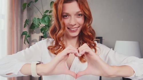Woman Makes Heart Shape with Her Hands