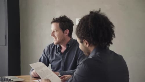 Man reviewing document and listening to explanation