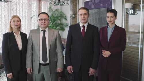 Business Team Poses in Modern Office Setting