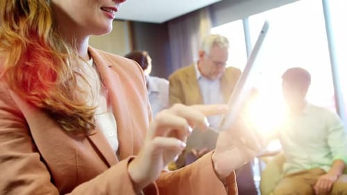 Woman Using Tablet in Bright Office Setting