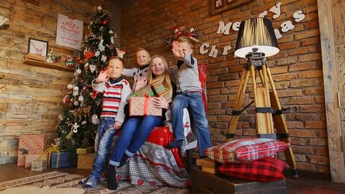 Happy Children Celebrating Christmas at Home with Gifts