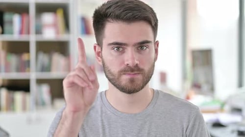 Portrait of No, Young Man Rejecting By Waving Finger